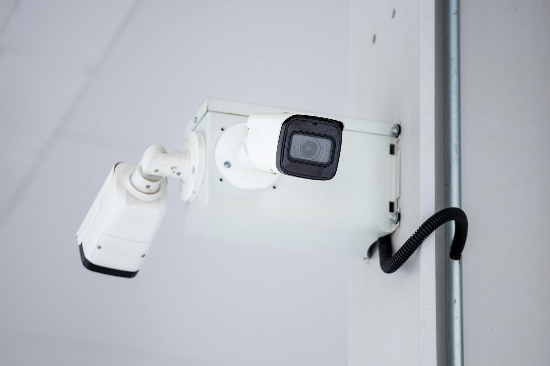 A close-up shot of a modern, mounted surveillance camera highlighting security and surveillance.