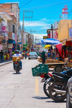 Lively street market scene in Rioverde, Mexico, showcasing local vendors and colorful shops.