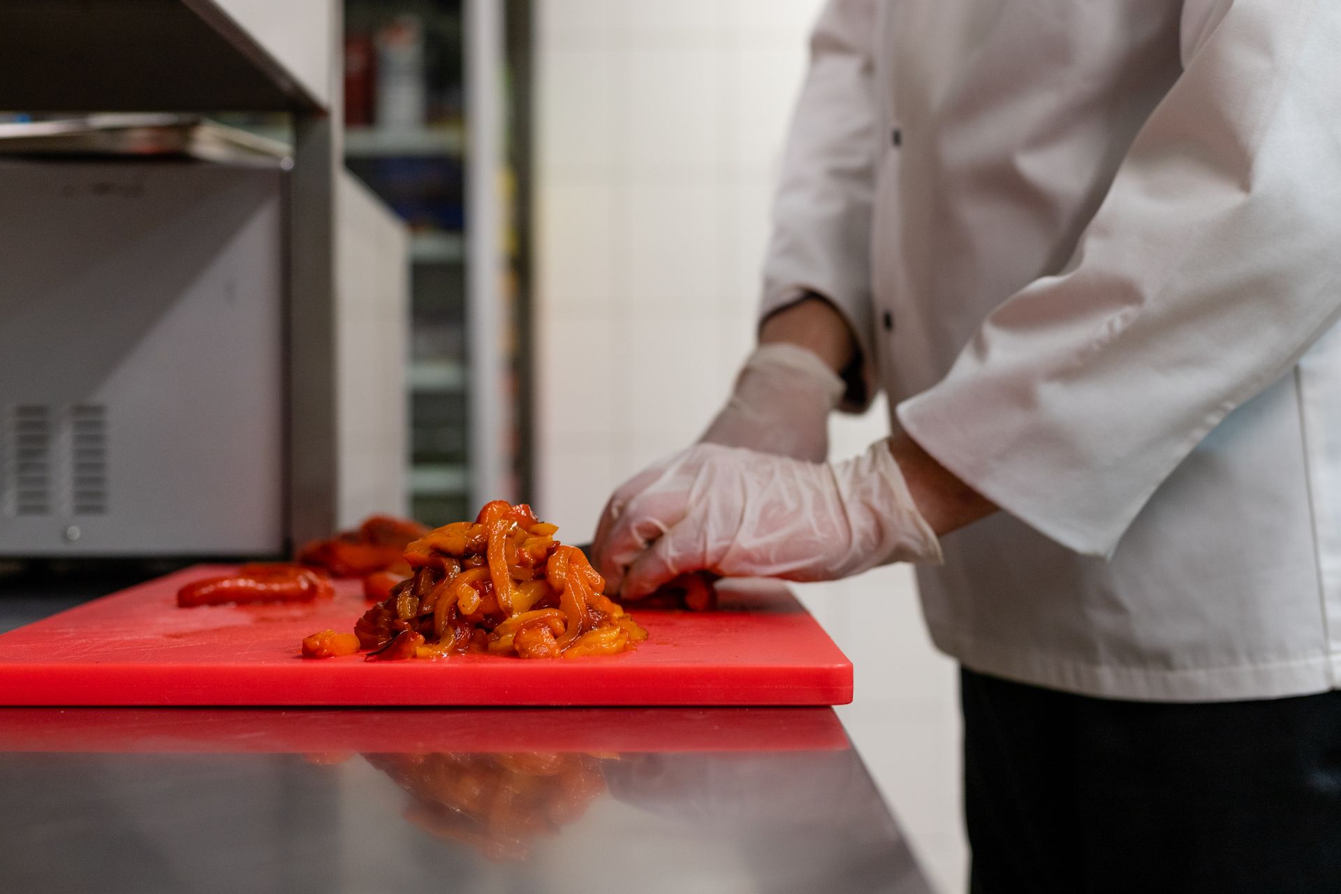 Chef chopping vegetables in a professional kitchen