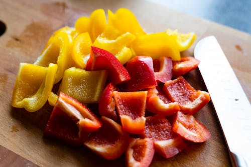 Sliced Yellow and Red Bell Peppers on Wooden Surface