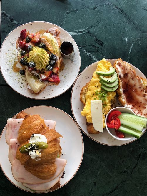 Free Delicious breakfast spread featuring croissants and fresh fruits, captured from above in a cozy Istanbul cafe. Stock Photo
