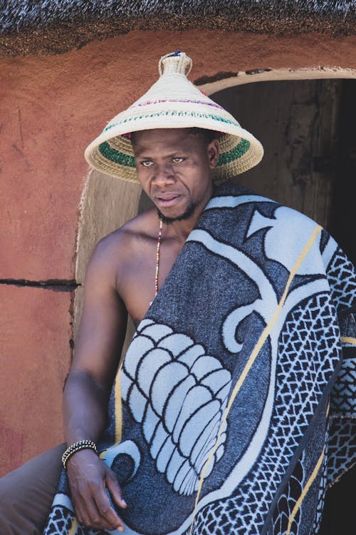 A Man Wearing a Blanket and a Fulani Hat