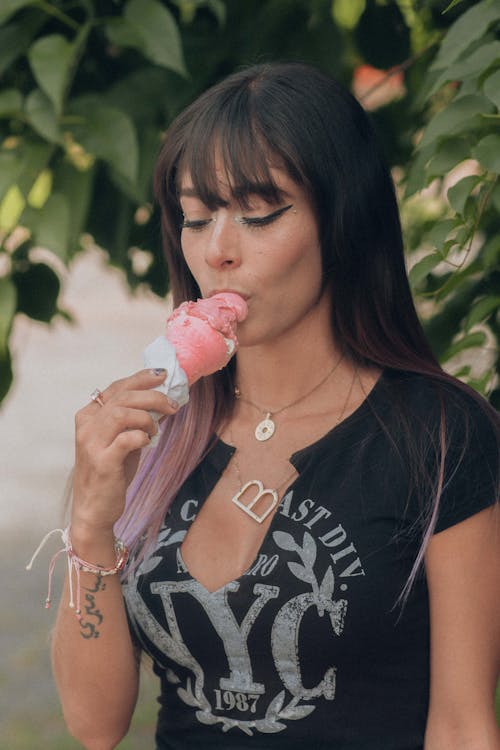 A Woman in a Black Shirt Eating Ice Cream