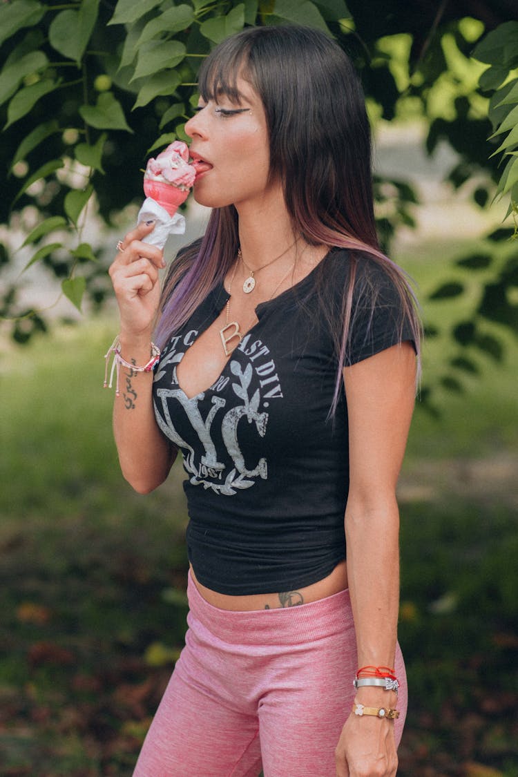 A Woman In A Crop Top Eating Ice Cream