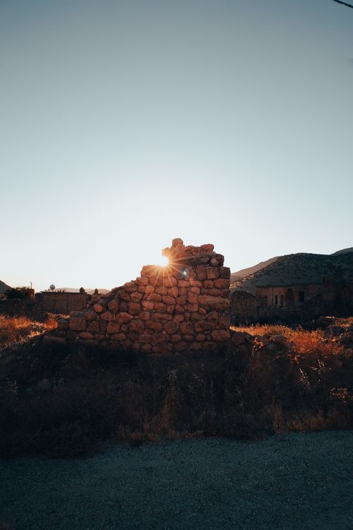 Free Captivating image of sunlight piercing through ancient stone ruins at sunset. Stock Photo