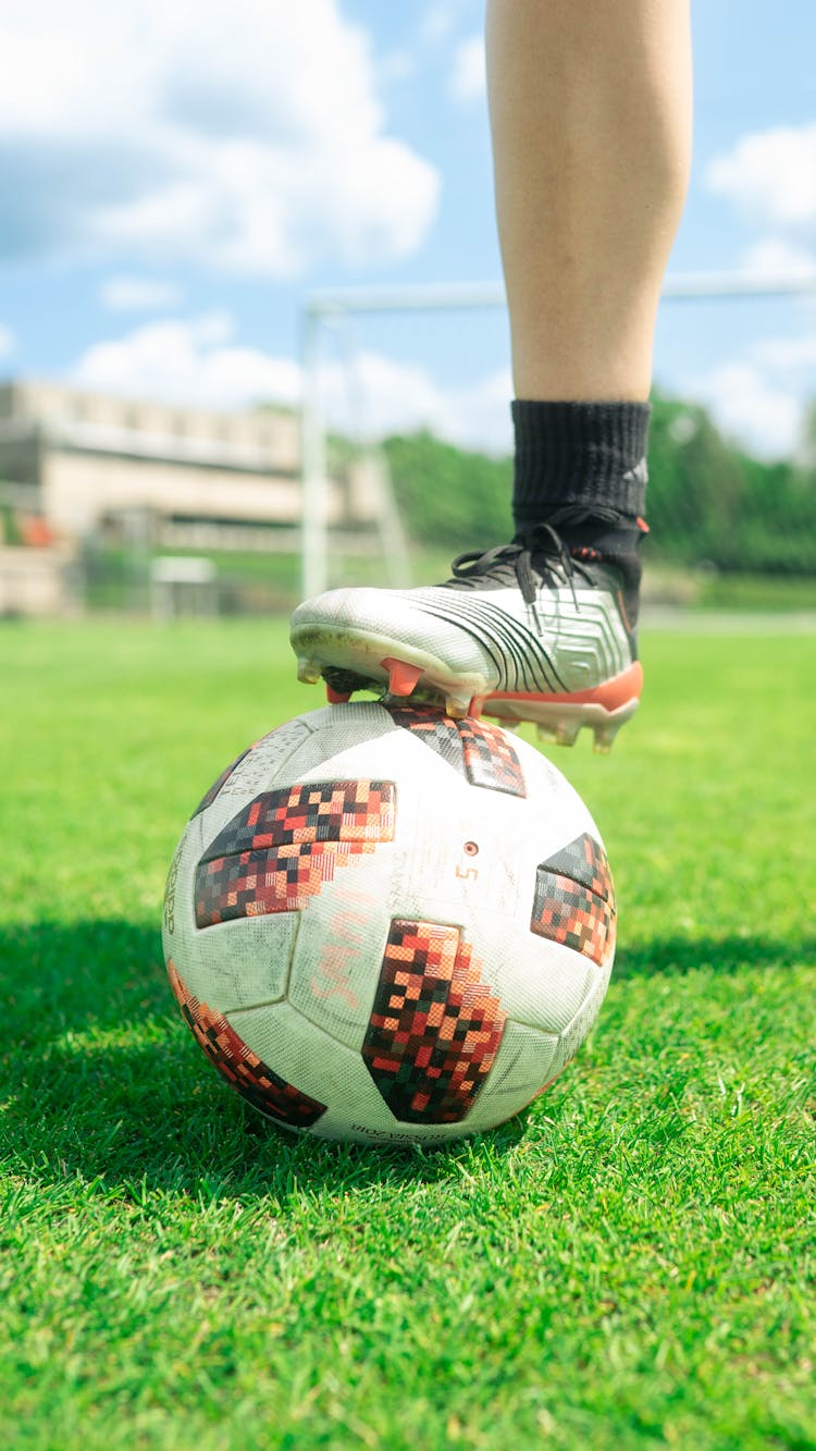 Person Stepping On Soccer Ball