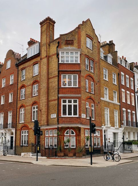 Charming Victorian-style brick building on a London street corner with classic architecture.