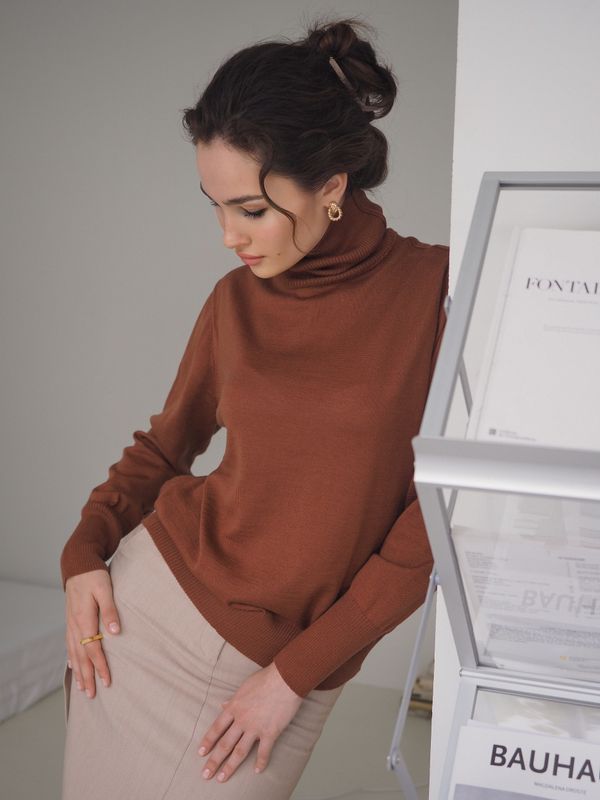 Brown turtleneck with cream wide-leg trousers