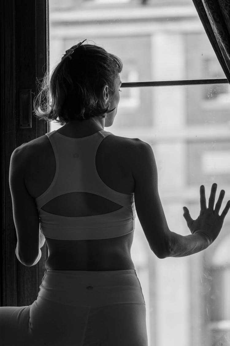 Woman Looking Through Window