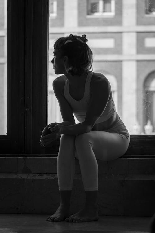 Woman Sitting by Window