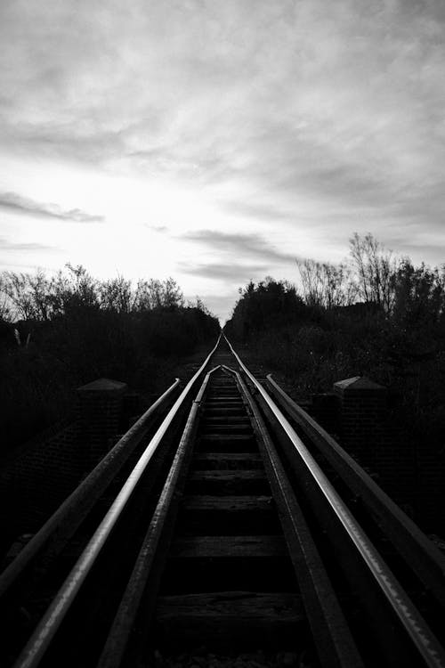 Grayscale Photo of a Train Track 