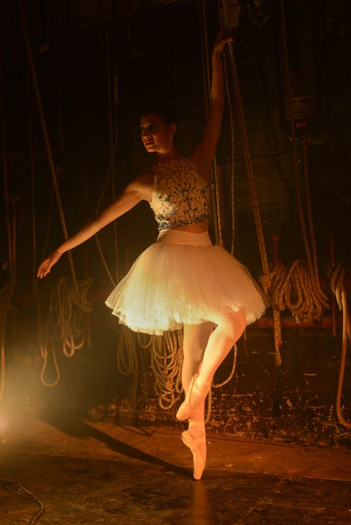 Free Graceful ballerina in a white tutu performing under stage lights in Mar del Plata, Argentina. Stock Photo