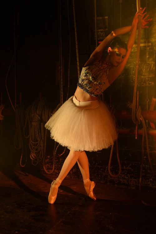 Free Elegant ballerina in dramatic light, showcasing poise and flexibility on stage. Stock Photo