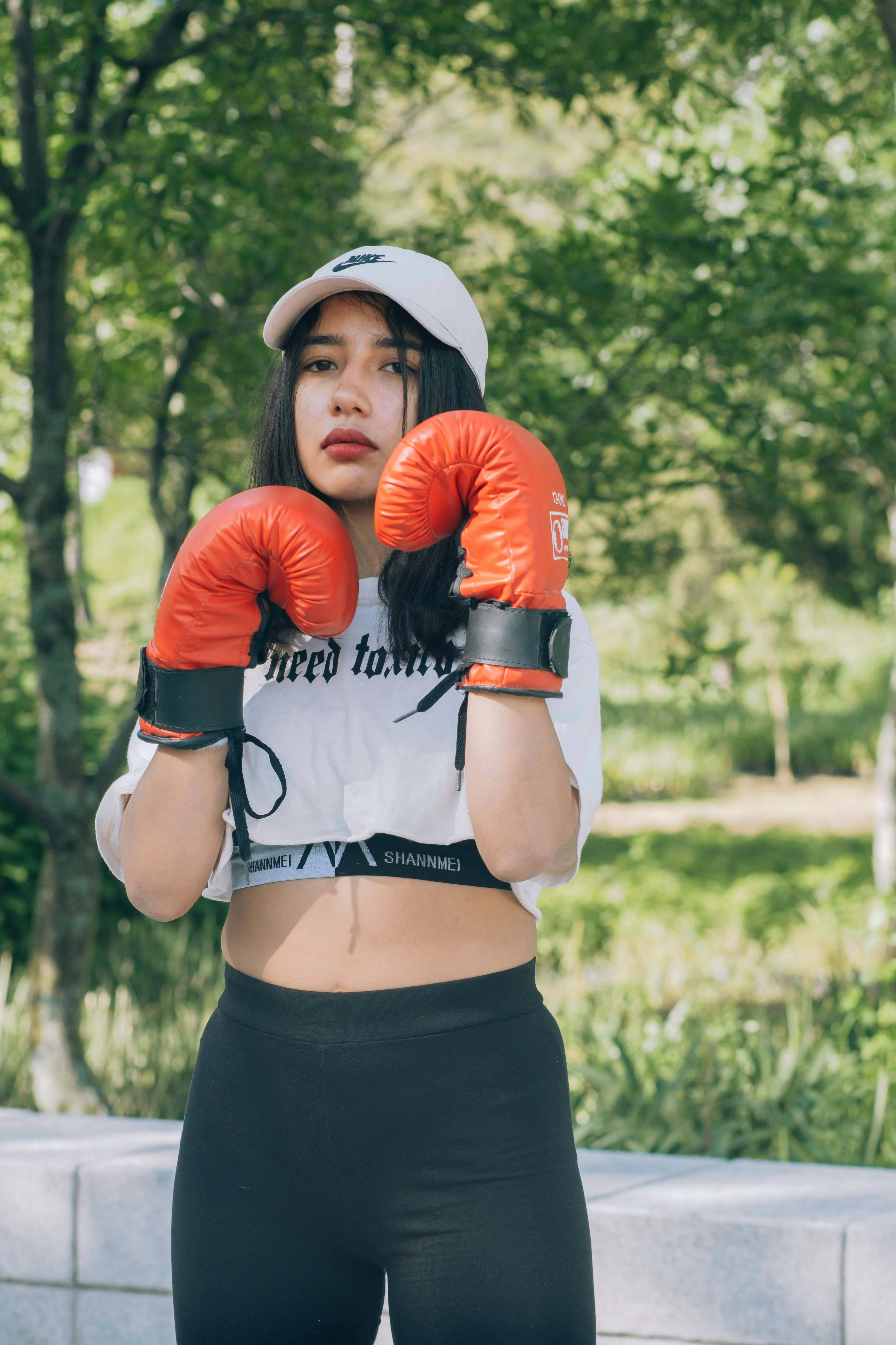 Woman in White Crop Top Wearing Red Boxing Gloves · Free Stock Photo