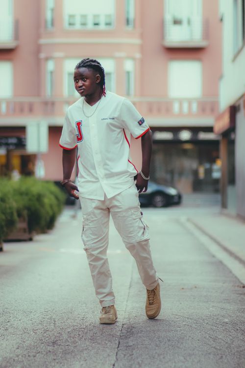Free Fashionable young man in casual urban outfit posing on city street. Stock Photo