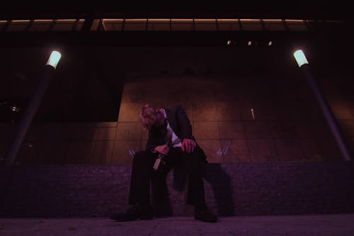 A Drunk Man Sitting on the Concrete