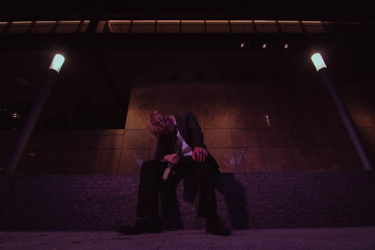 A Drunk Man Sitting On The Concrete