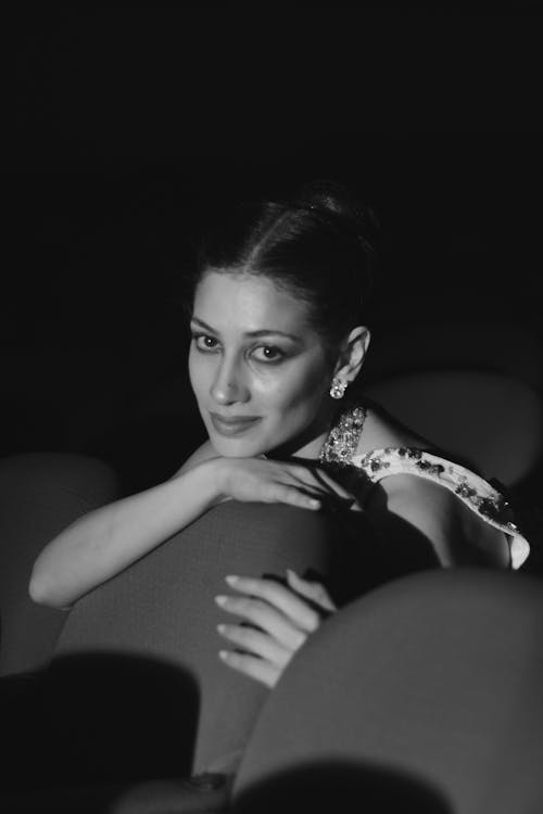 Beautiful Woman leaning her Head on a Theatre Seat