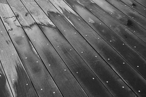 Grayscale Photo of Wooden Floor