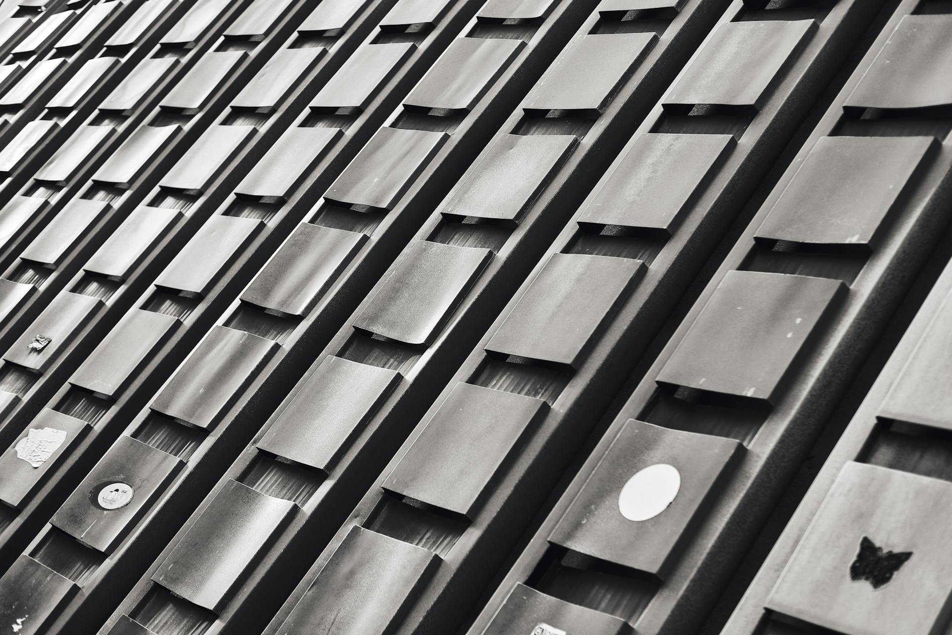 Close-up of a modern building facade with geometric patterns in black and white.