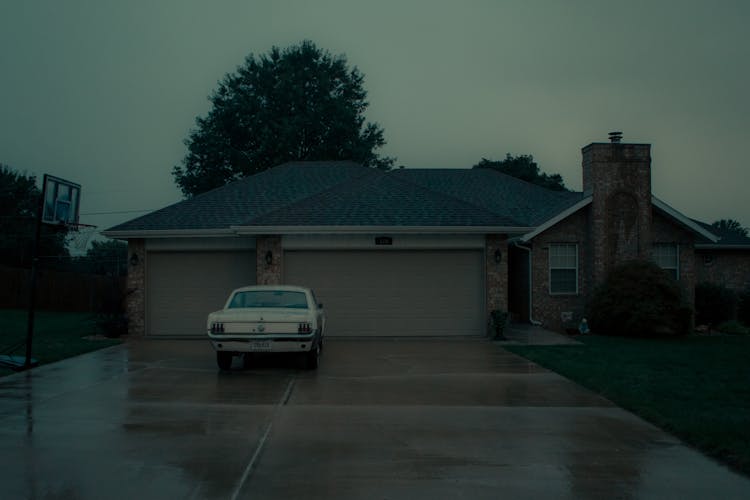 White Car Parked In Front Of Garage