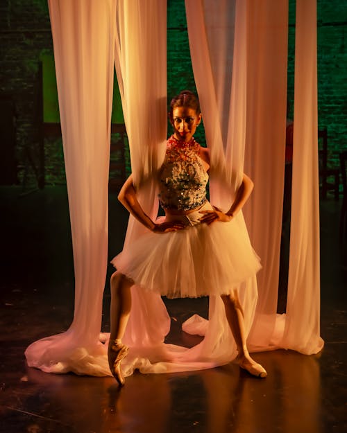 Free A Ballerina Posing with Curtain Stock Photo