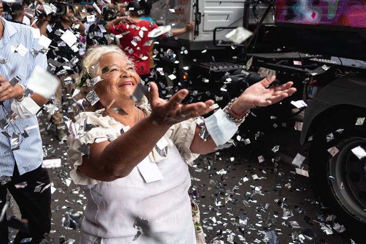 Elderly Woman Enjoying The Falling Confetti