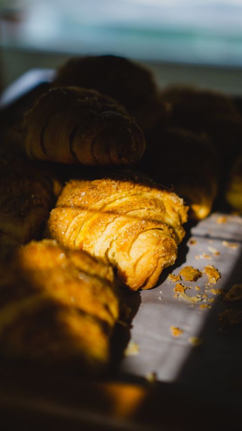 Freshly baked croissants catching sunlight — Muhammad Fawdy on Pexels