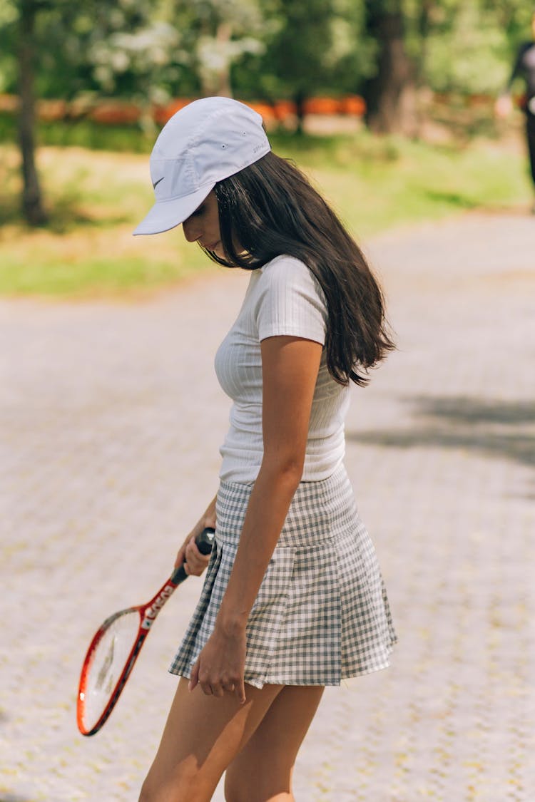 A Woman Holding A Tennis Racket 