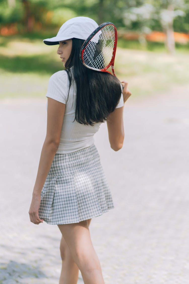 A Woman Holding A Tennis Racket 