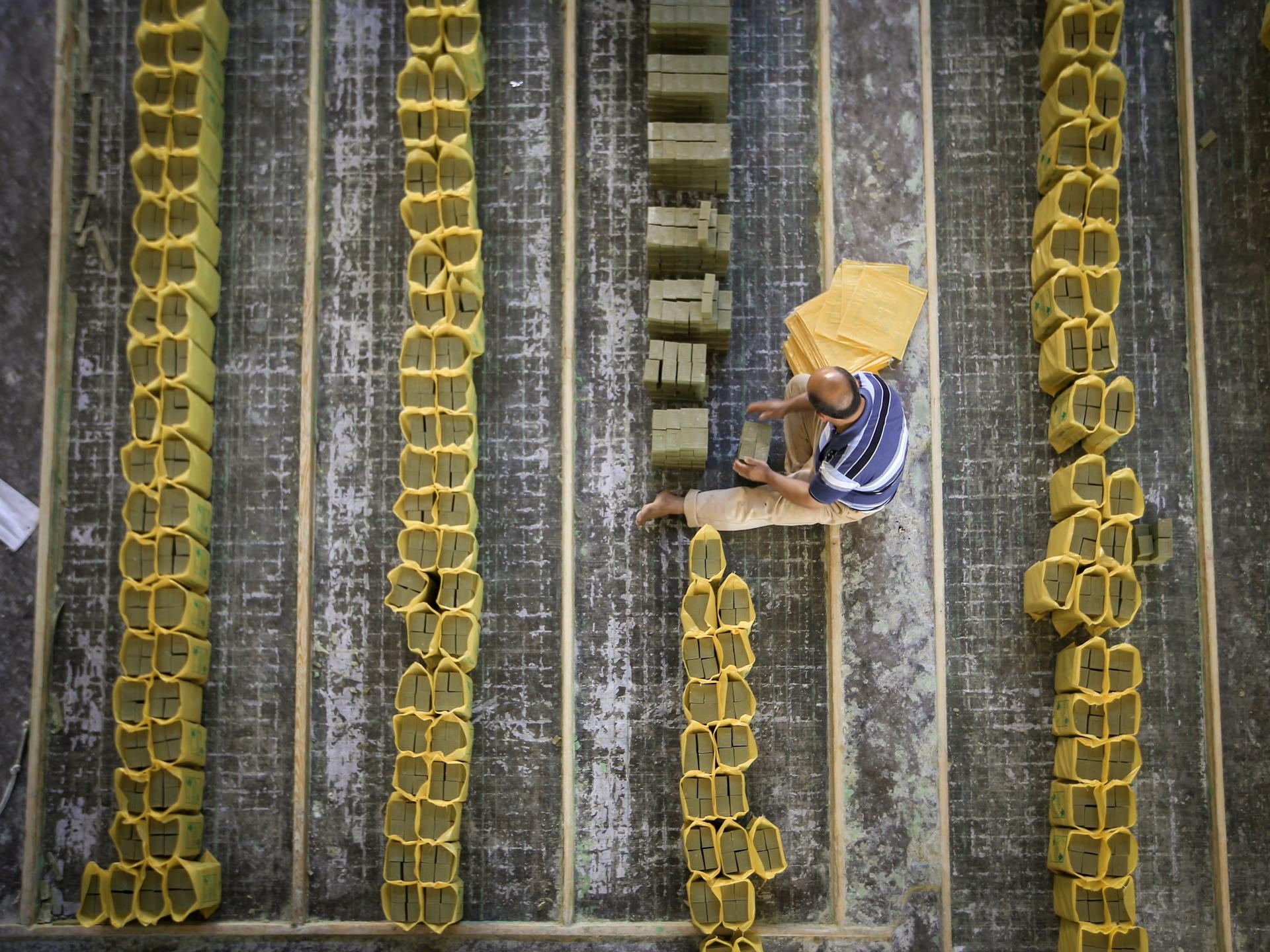 A Top View of a Man Packing Bar Soaps