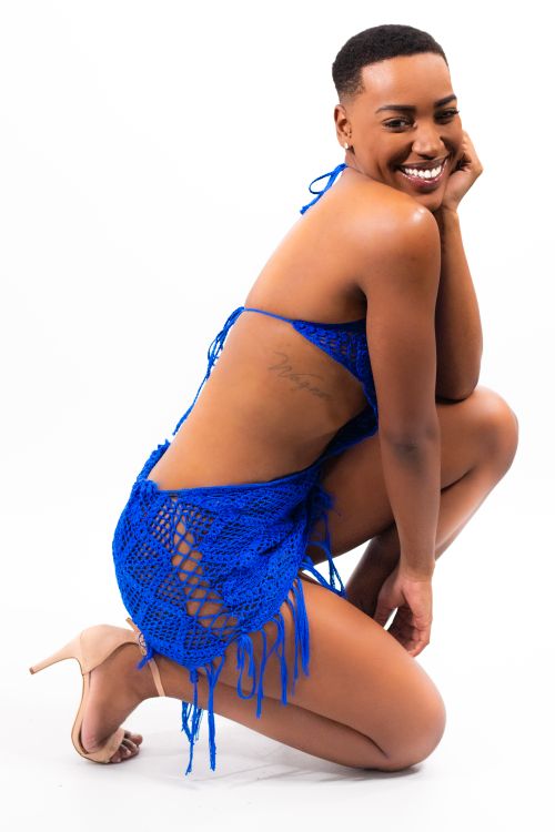 Free Confident model in a blue crochet bikini posing with a bright smile. Stock Photo