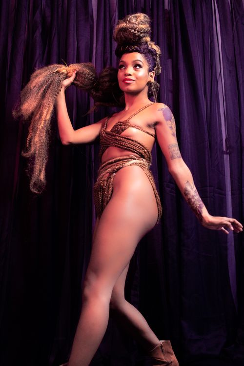 Free Captivating image of a dancer with unique hair and outfit performing on stage. Stock Photo