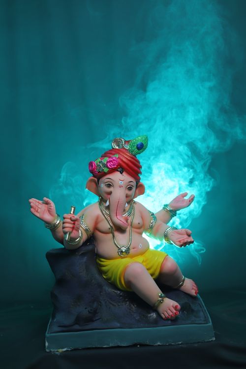 Free Captivating image of a Ganesha figurine surrounded by ethereal blue smoke, symbolizing spirituality. Stock Photo