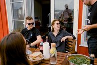Friends gather for a casual outdoor meal on a sunny day in Bolotovo, Russia.