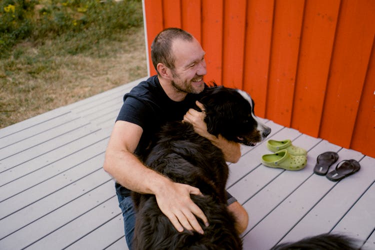 A Man Hugging His Pet Dog