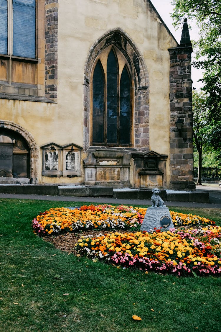 Facade Of The Greyfriars Kirk And Flowers In Front Of It, Edinburgh, Scotland