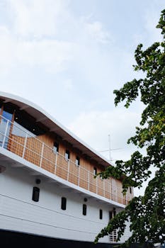 Contemporary yacht design featuring a sleek wooden facade and clear skies, offering a luxurious and serene maritime experience.