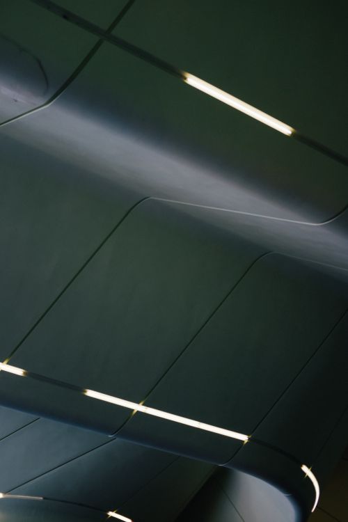 Free Abstract view of a modern aircraft's ceiling with smooth curves and integrated lighting. Stock Photo