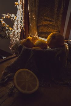 Artistic still life of lemons illuminated by soft, warm lighting. Perfect for kitchen or culinary themes.