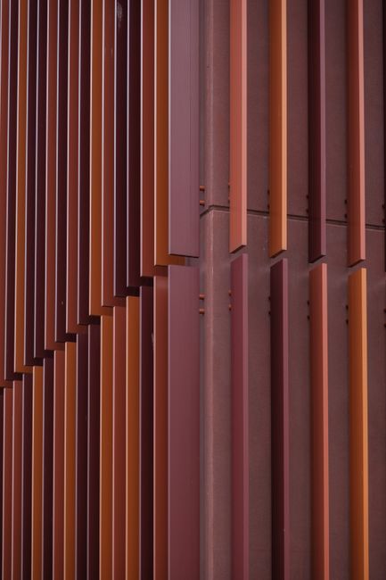 Close-up of a modern architectural facade showcasing vertical stripes pattern in urban design.