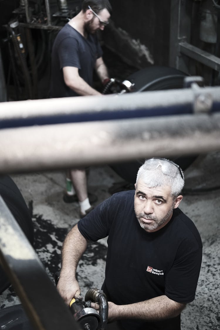 Men Working In A Car Garage