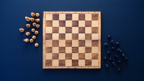 Brown Chess Board Game on Blue Surface