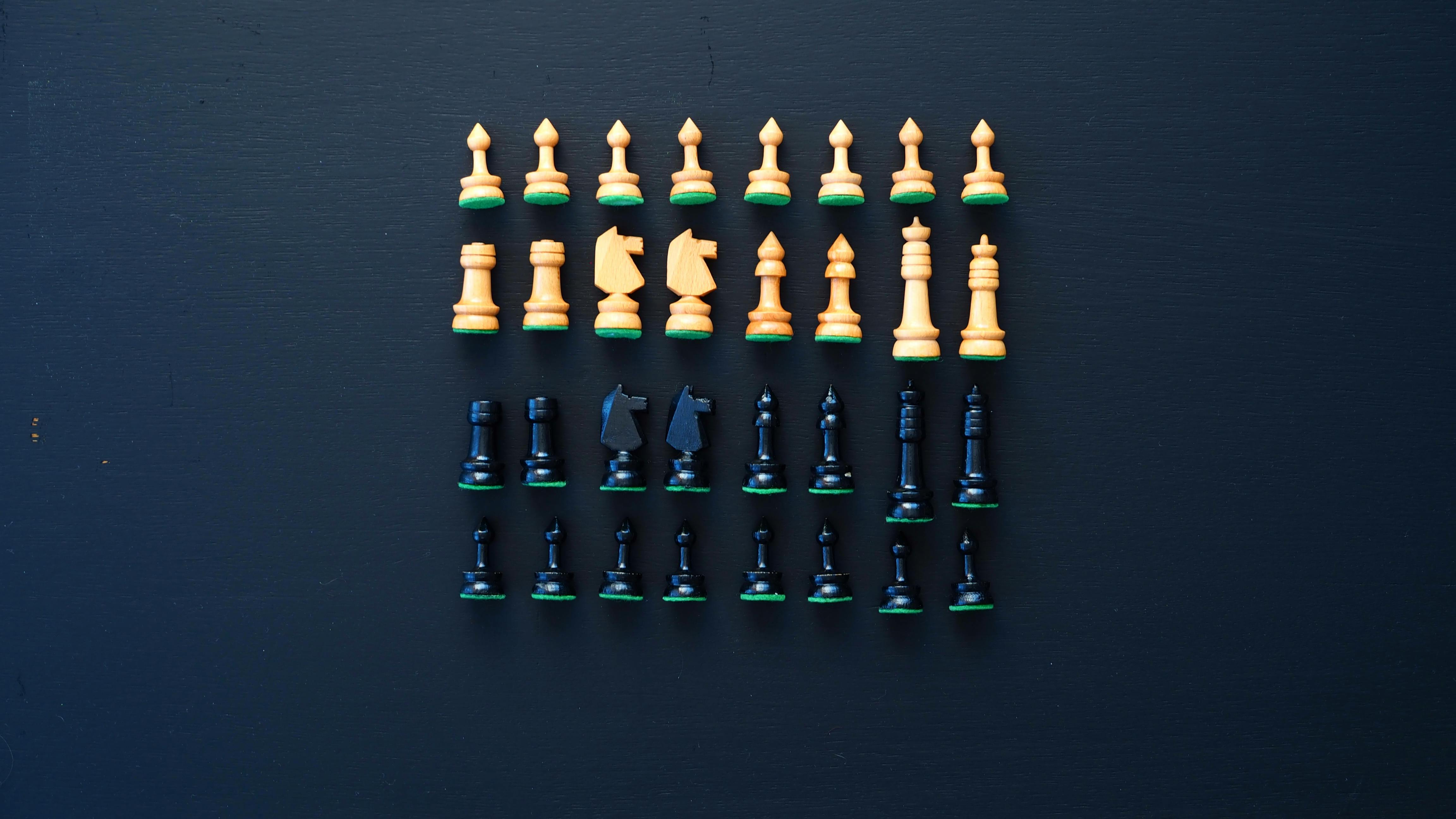 Gold Chess Pieces on Black Surface · Free Stock Photo