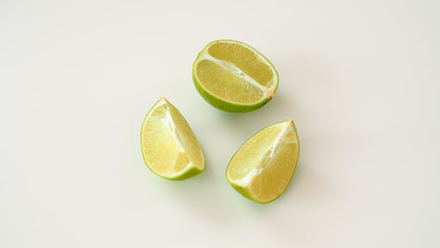 Minimalist image of fresh lime slices on a white backdrop, perfect for citrus-themed designs.