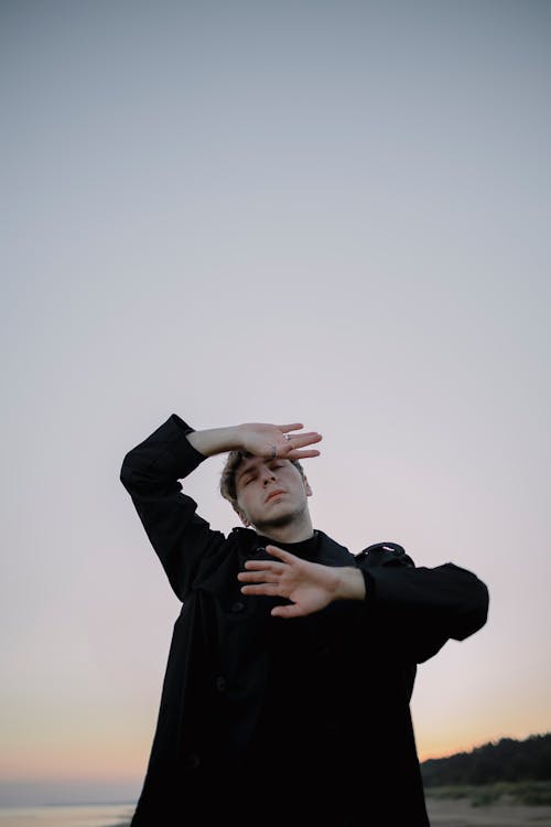 Man Posing with Clear Sky behind