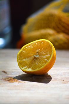 Vibrant close-up of a half lemon on a wooden board, highlighting its juicy texture.