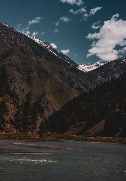 Free Breathtaking view of snow-capped mountains and river in Murree, Pakistan. Stock Photo
