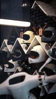 A collection of motorcycle helmets displayed on geometric shelves in a modern store setting.