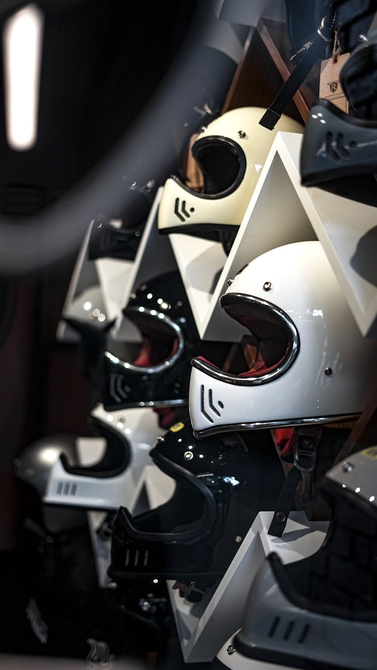 White And Black Helmets On White Wooden Shelf